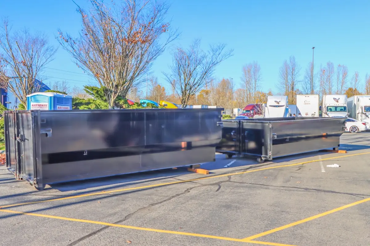 Professional dumpster rental service with roll-off container on residential driveway in Antioch